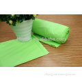 Green biodegradable plastic garbage bags on roll